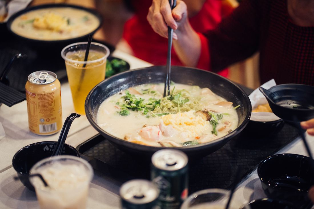 A bowl of collagen soup with noodles and greens