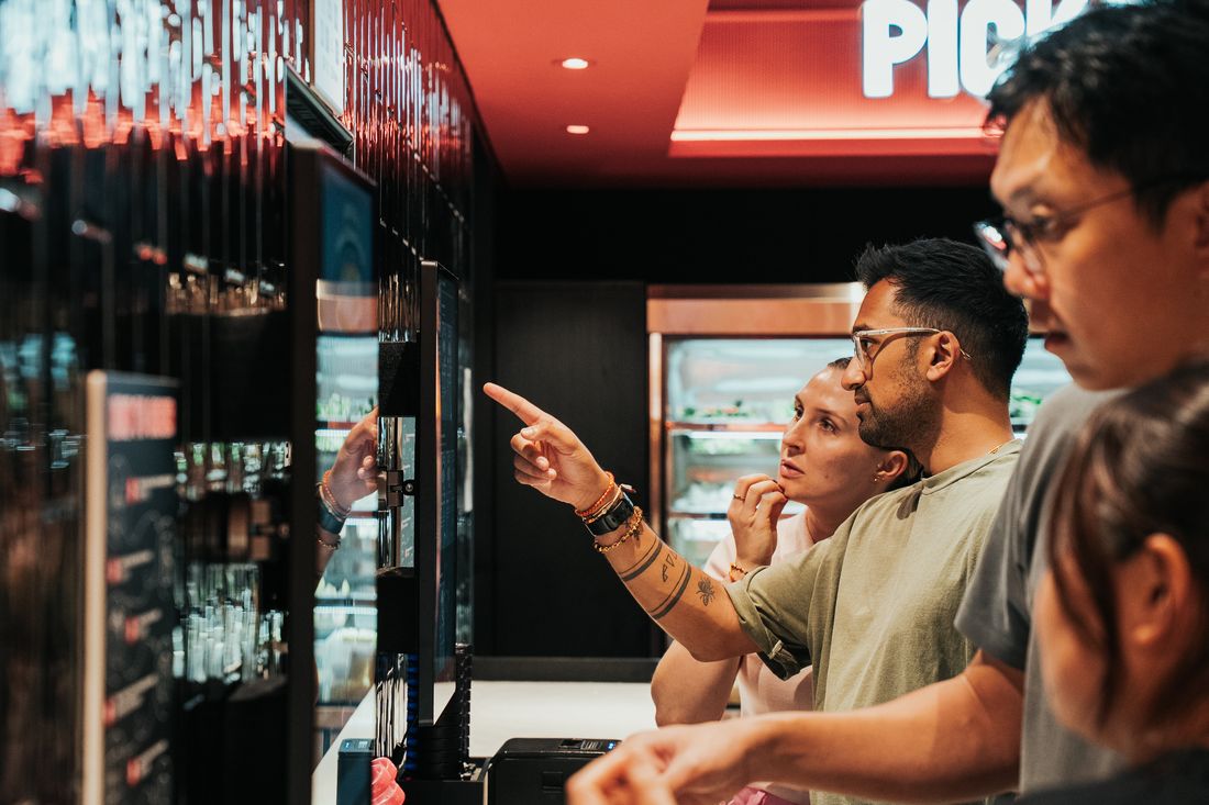 Friends ordering at the kiosk
